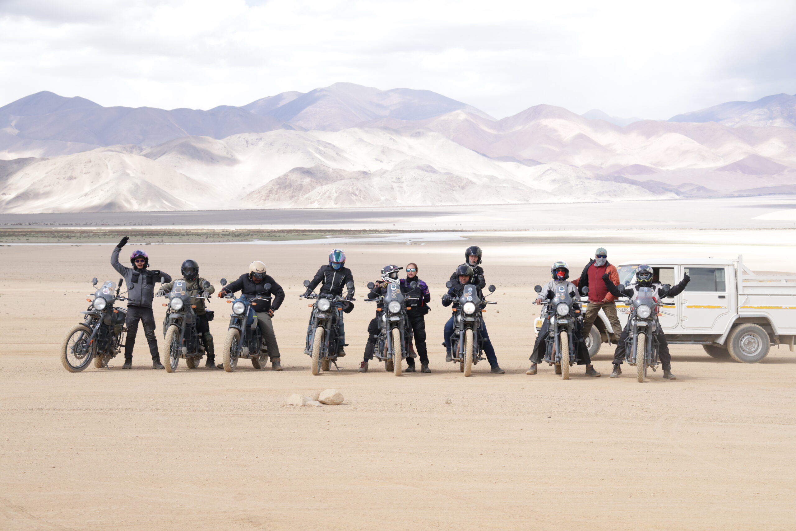 Motorcycles lined up cleanly at a high altitude military checkpoint in Ladakh